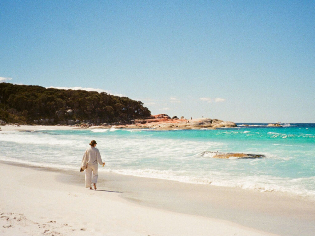 Author Laura walking on the white beach at Cosy Corner