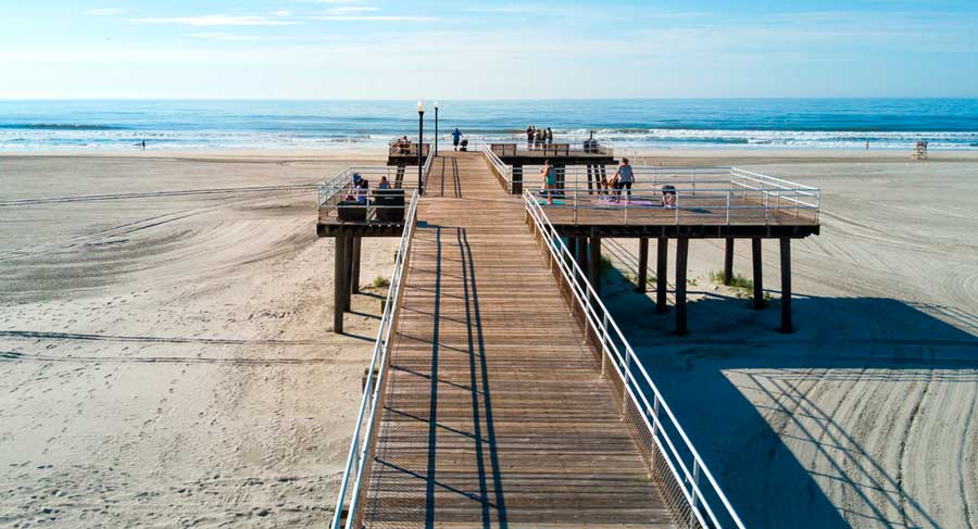 View of a pier in Wildwood Crest Beach and the clear blue sky in New Jersey