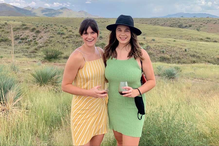 The author with her friend holding their wine glass during a wine tasting in Sonoita