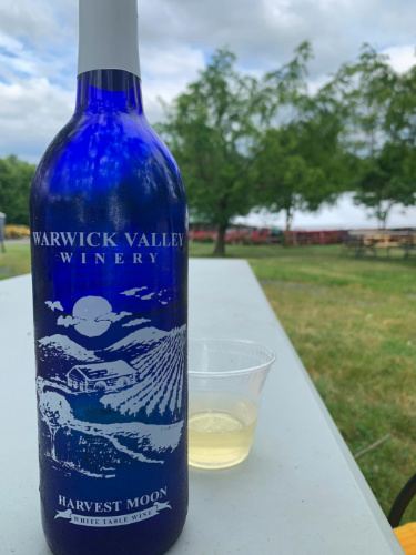 A bottle of white wine on a table in Warwick Valley Winery