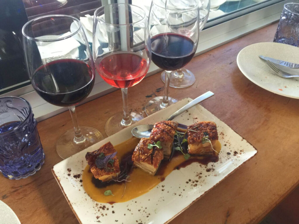 A plate of food and glasses of wine for tasting at Echale