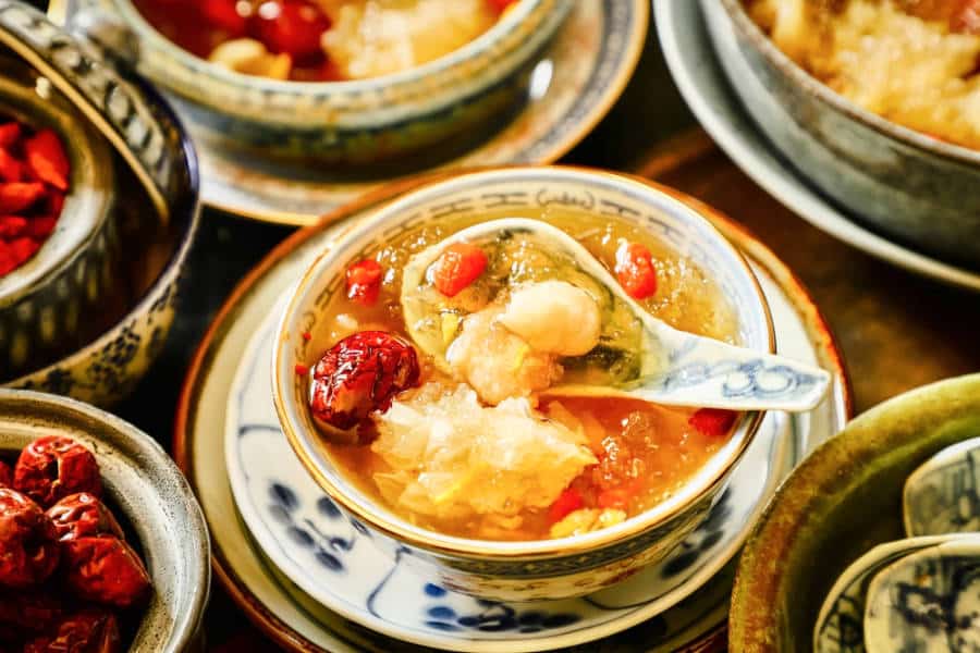 A bowl of Chinese soup with other dishes in Wing Lei restaurant.