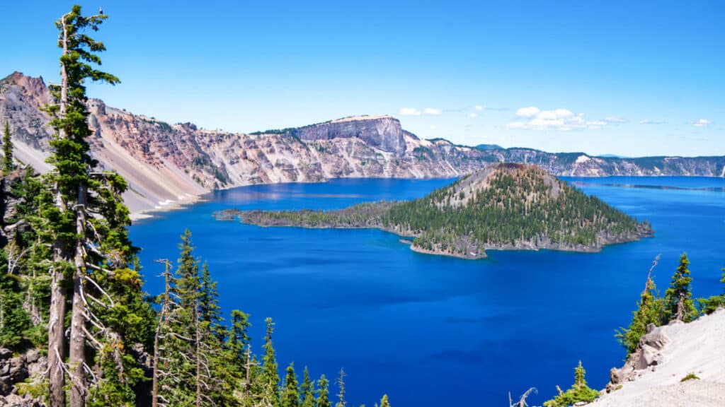 View of the Wizard Island on a deep blue lake in Crater Lake National Park