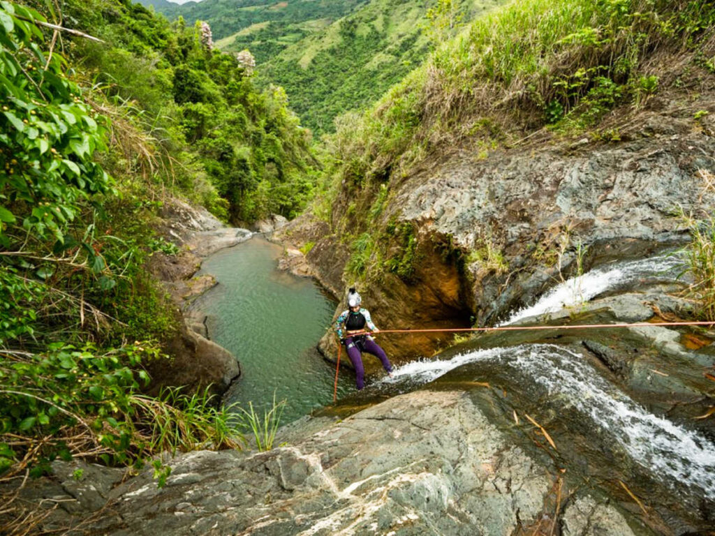 A woman canyoneering on the waterfalls