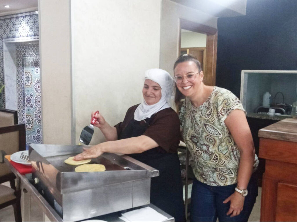 The author Catherine Driver with a Moroccan woman cooking
