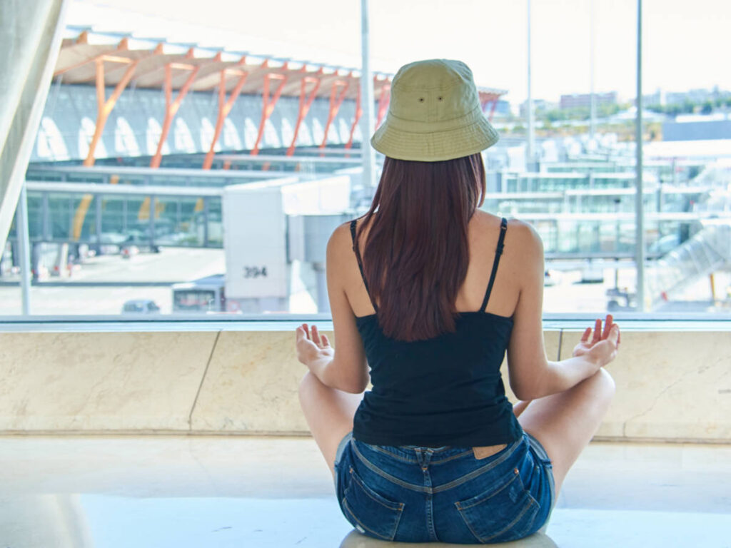 A woman doing yoga inside the airport