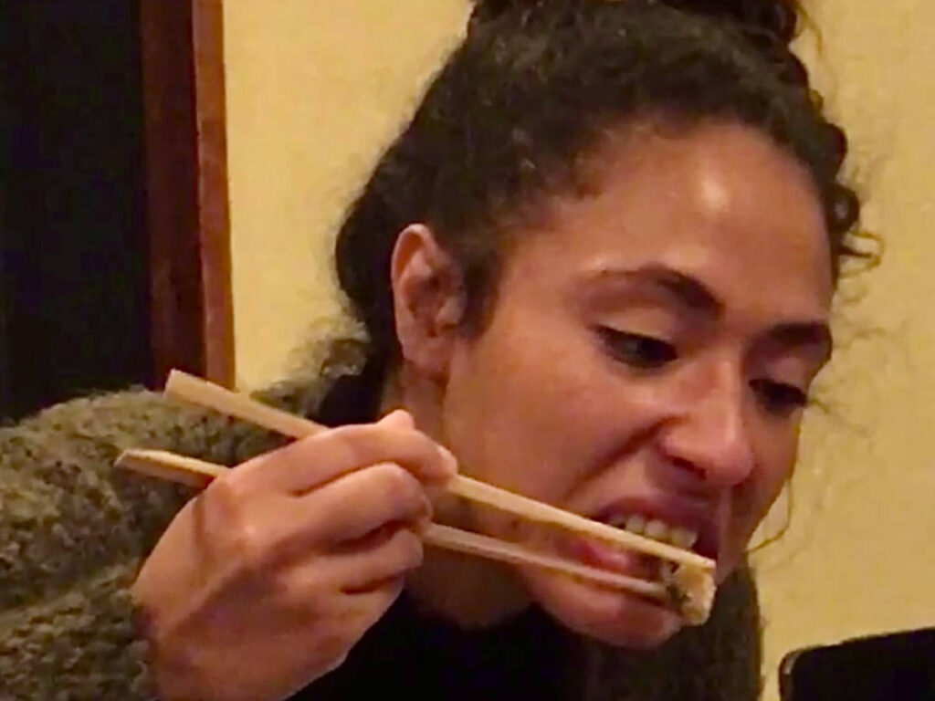 The author's friend taking a bite on her food