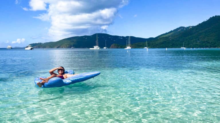 A woman with a floater while floating in the Virgin Islands sea