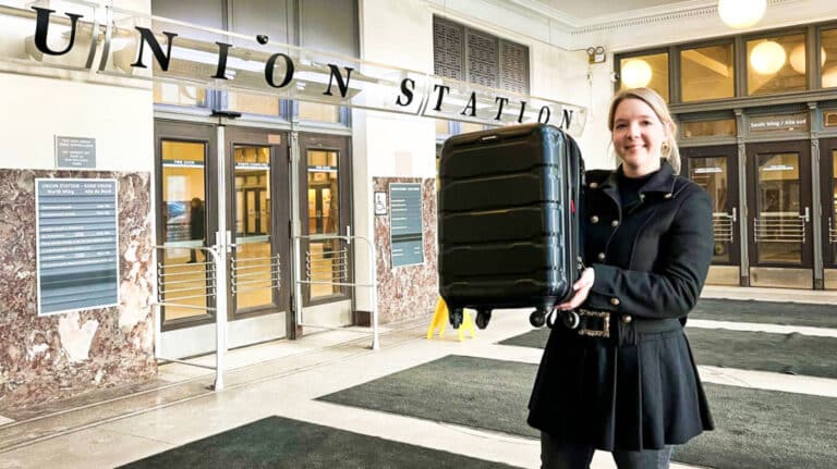 The author Taylor Herperger carrying a black luggage at the Union Station