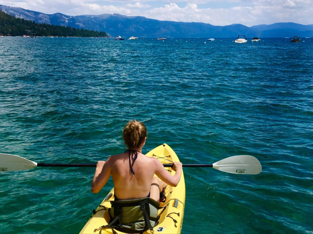 A woman kayaking on the north shore of Lake Tahoe