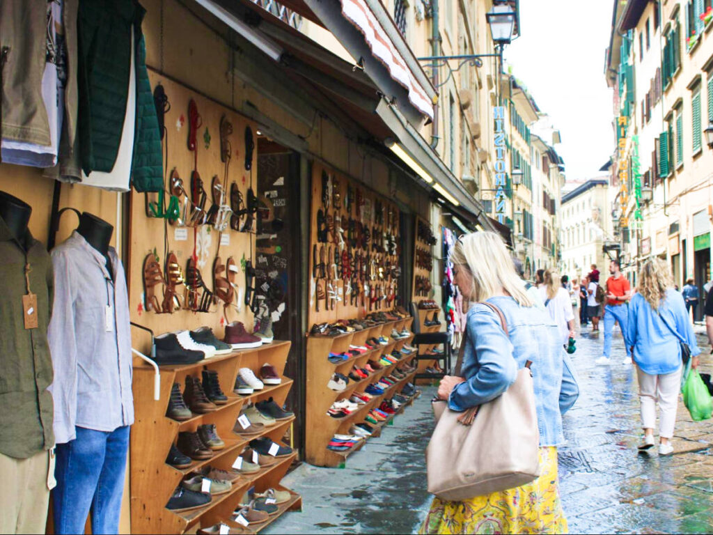 A woman shopping on the displayed items in the side of the street in Florence