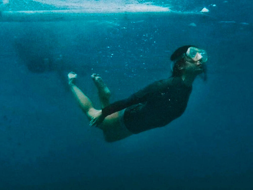 A woman snorkeling under the water