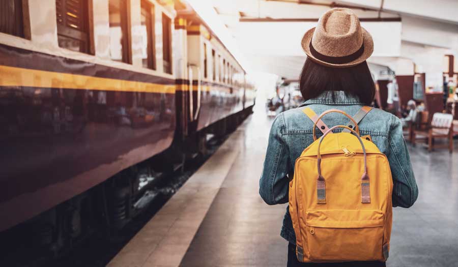 A woman traveler with her backpack on a train station