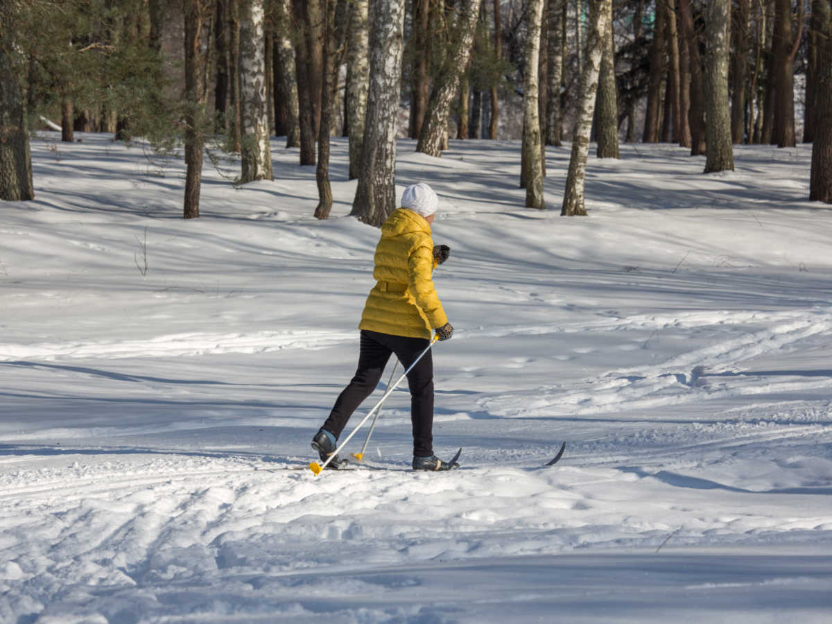 A female skier walking on the snow