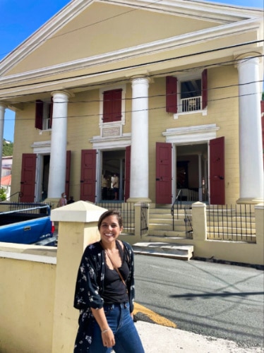 A woman posing in front of The Dutch Reformed Church