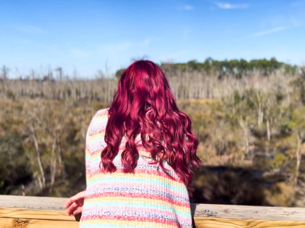 A red hair woman overlooking the view at Tillie K. Fowler Regional Park