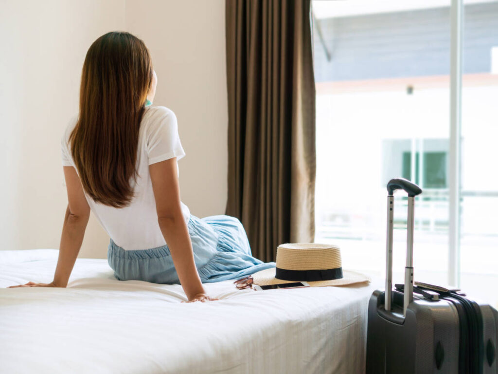 A woman admiring the view from her room
