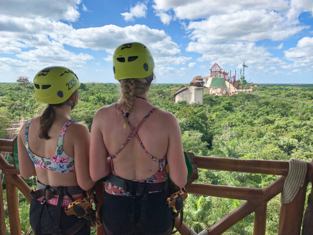 Two girls enjoying the overlooking view while getting ready to zipline