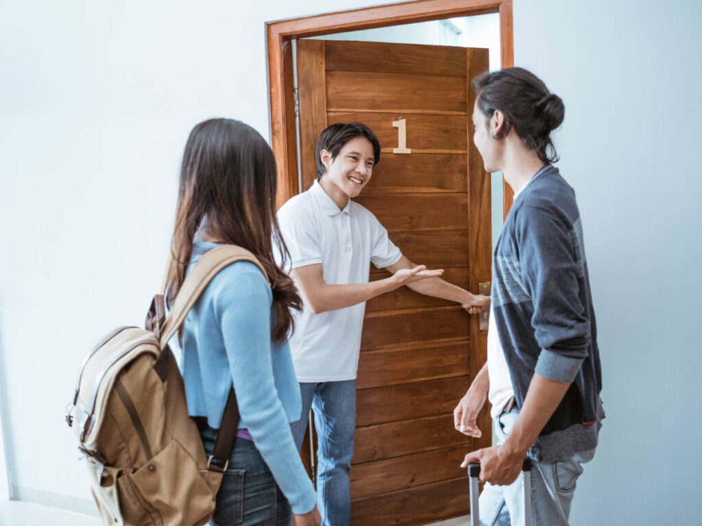 A worker welcoming guests on their room