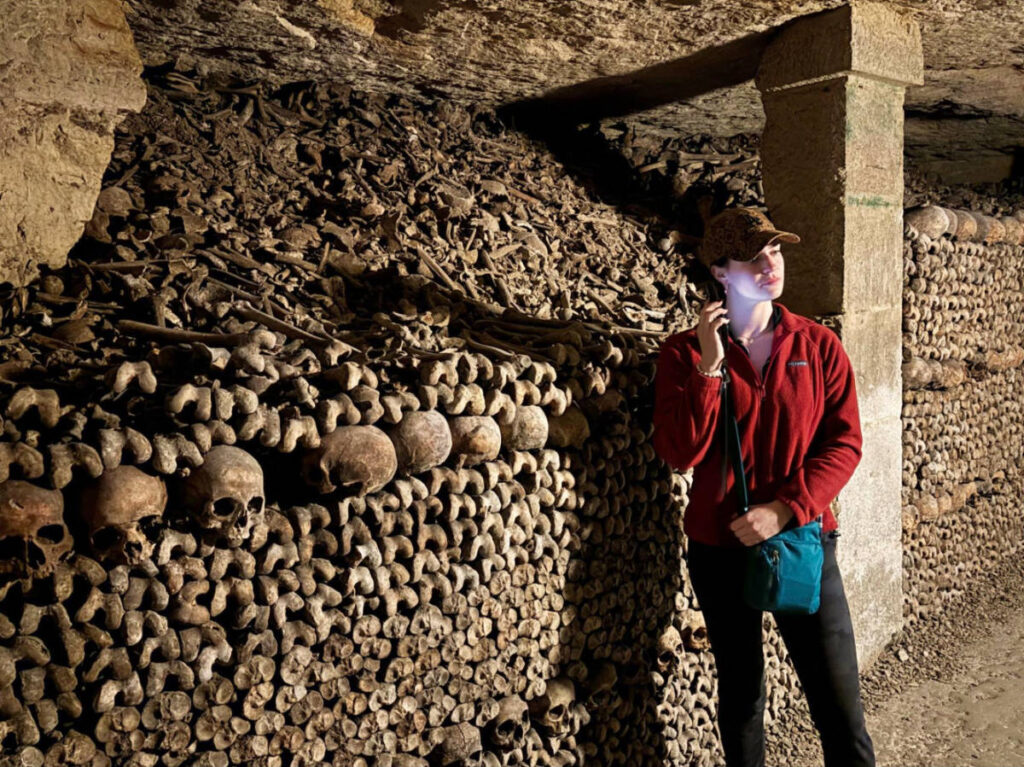 Writer Betty listening to her e-tour device at the Paris catacombs