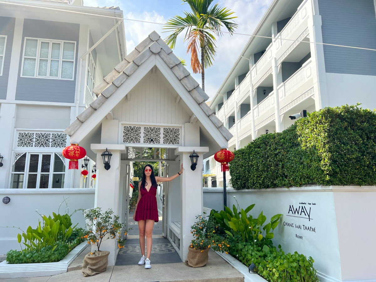 Writer Clara standing at the entrance of Away Chiang Mai Thapae Resort