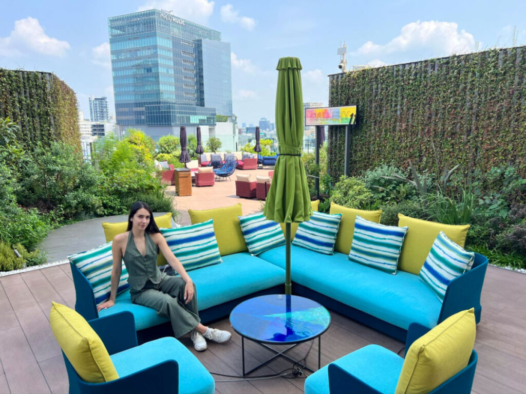 Writer Clara relaxing on the couch at The Hotel Indigo’s terrace