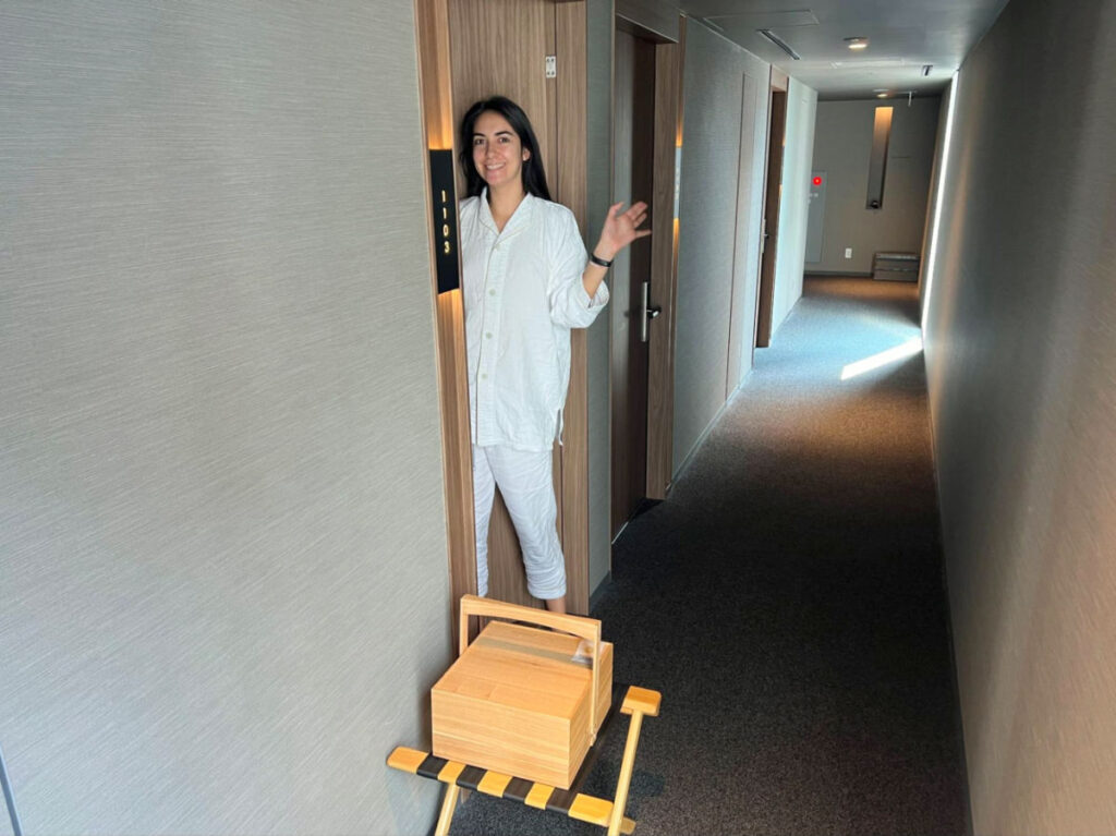 Writer Clara in her pajamas getting the breakfast in a box at the karaksa hotel premier Tokyo Ginza