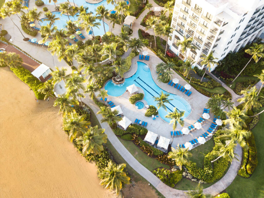 Aerial view of the Wyndham Grand Rio Mar and the pool area surrounded by greenery