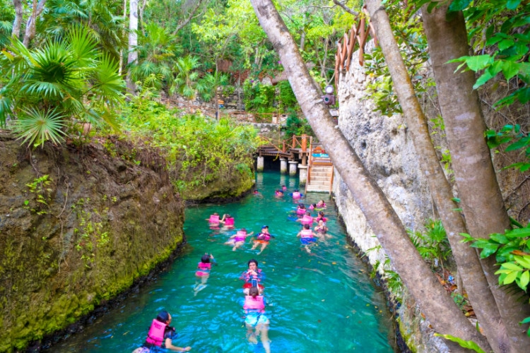 Tourists swimming on the Lazy River at Xcaret Theme Park