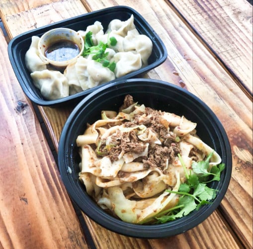 A bowl of spicy cumin lamb biang noodles and shrimp dumplings from Xi’an Noodles