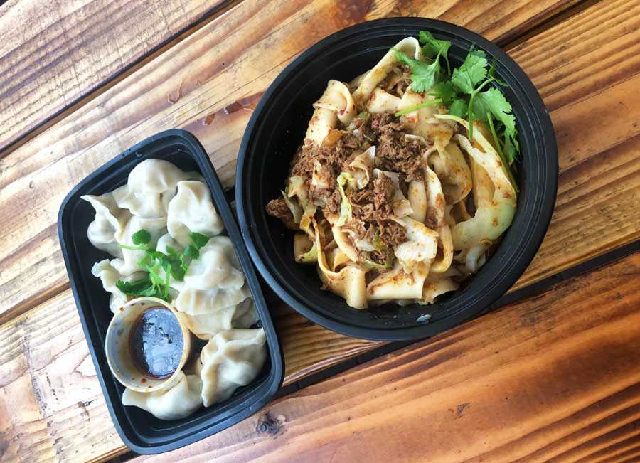 View of dumplings and noodles on top of a table in Xi'an Noodles