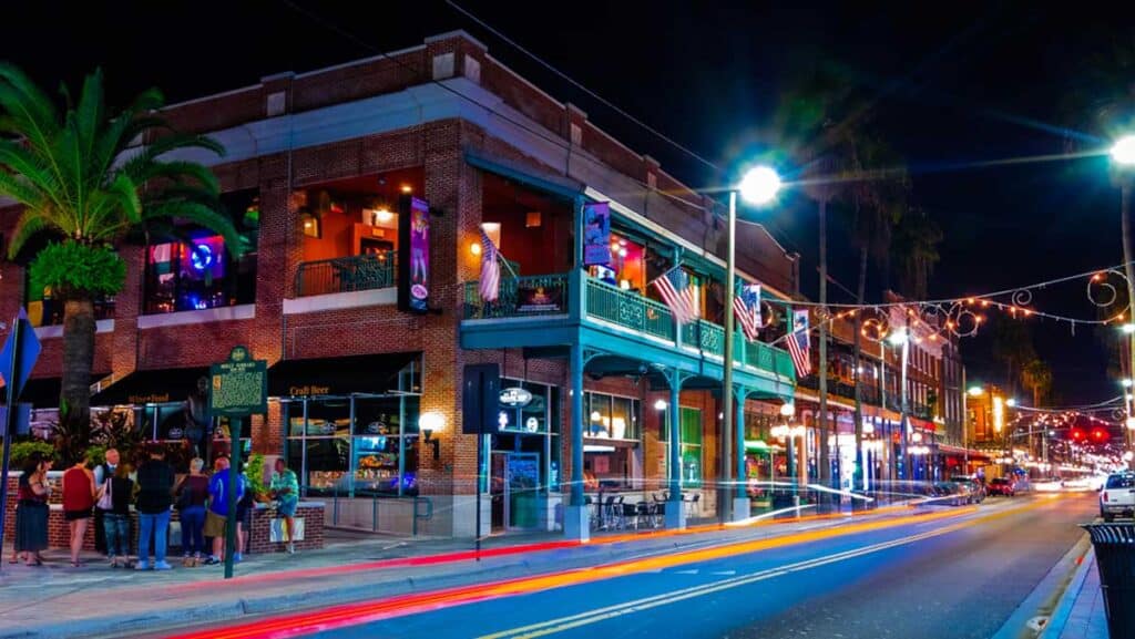 Long exposure of lights on the tourist road with restaurants and shops of Ybor City at night