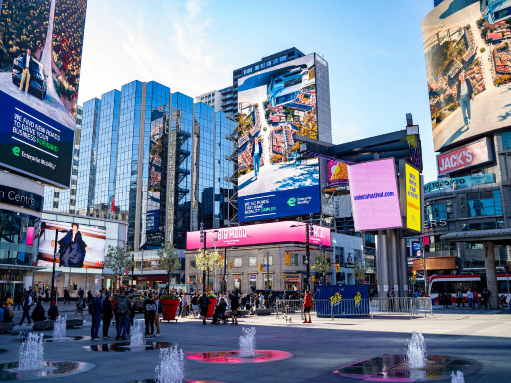View of People and buildings with ads seen at Yonge-Dundas Square