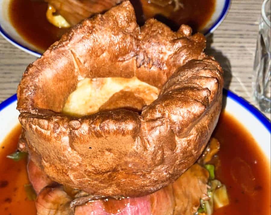 Closeup view of the huge Yorkshire Pudding on a plate