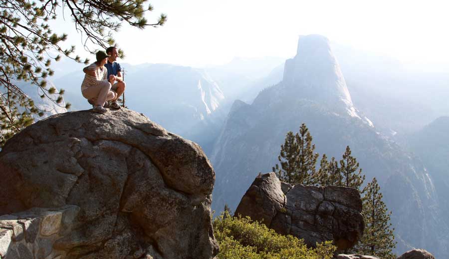 A couple admiring the view in Yosemite National Park during their hike