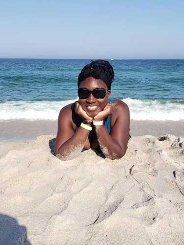 Yvette Griffith smiling for a photo at the sandy Ortley Beach