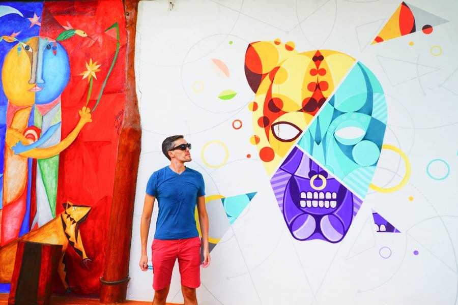 Travel Lemming founder Nate Hake against the colorful mural in Hotel Zentik Project
