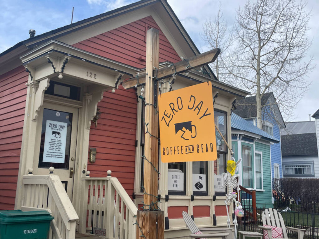The bright yellow signage of Zero Day Coffee outside