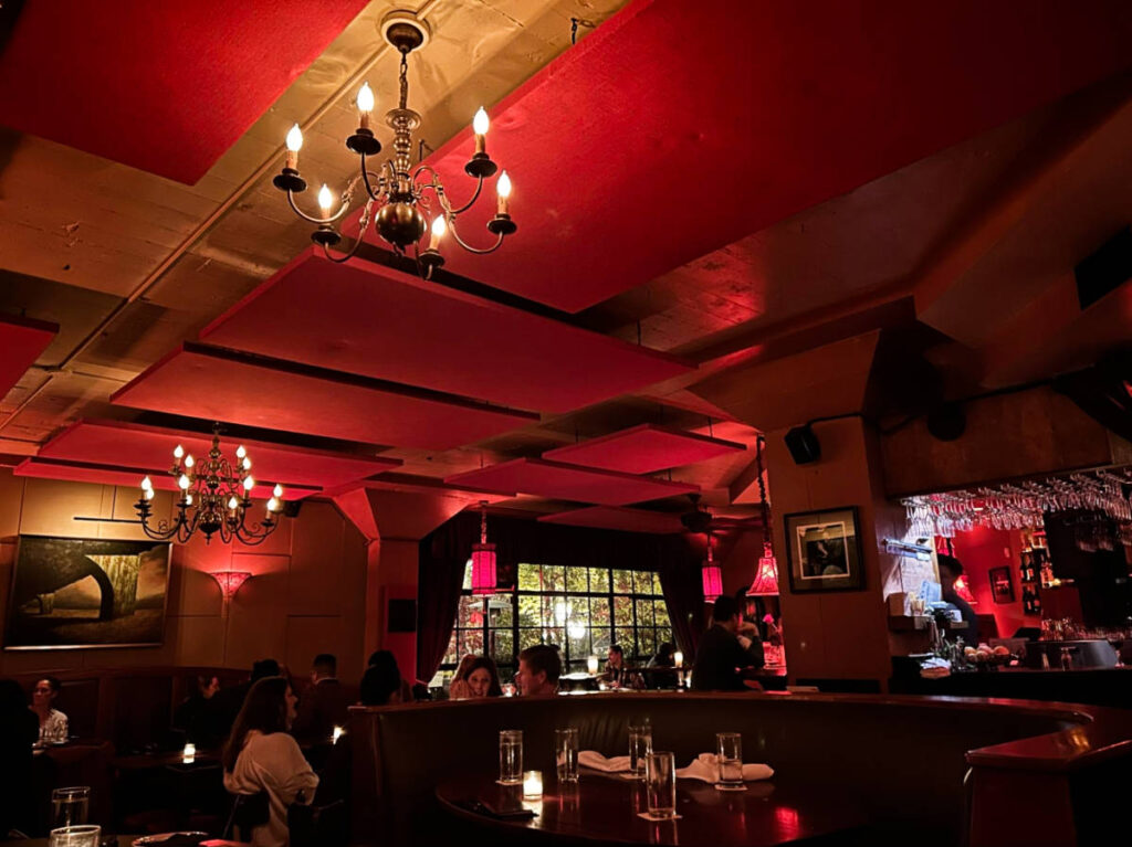View of the people dinging inside the cozy red interior of Zig Zag Cafe