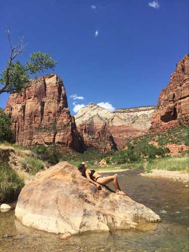 The author laying on a big rock in Zion National Park river