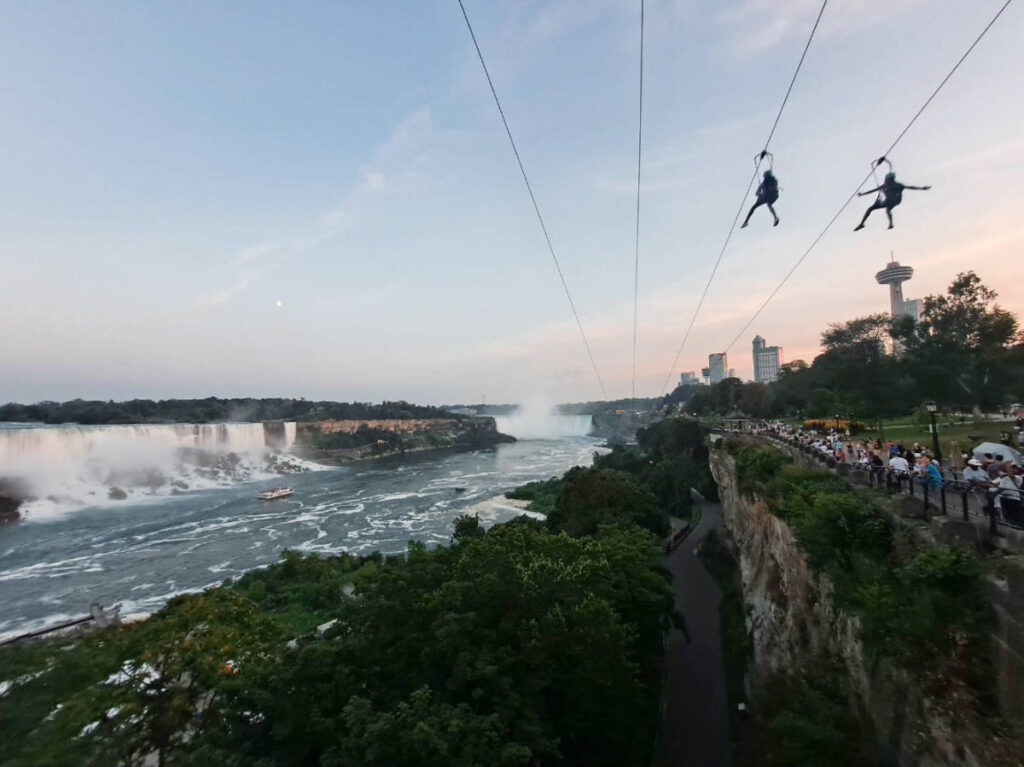 People doing zipline with the Niagara Falls view