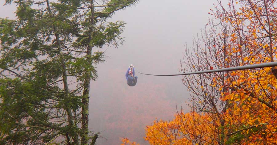 A woman ziplining at the Blue Ridge Mountains