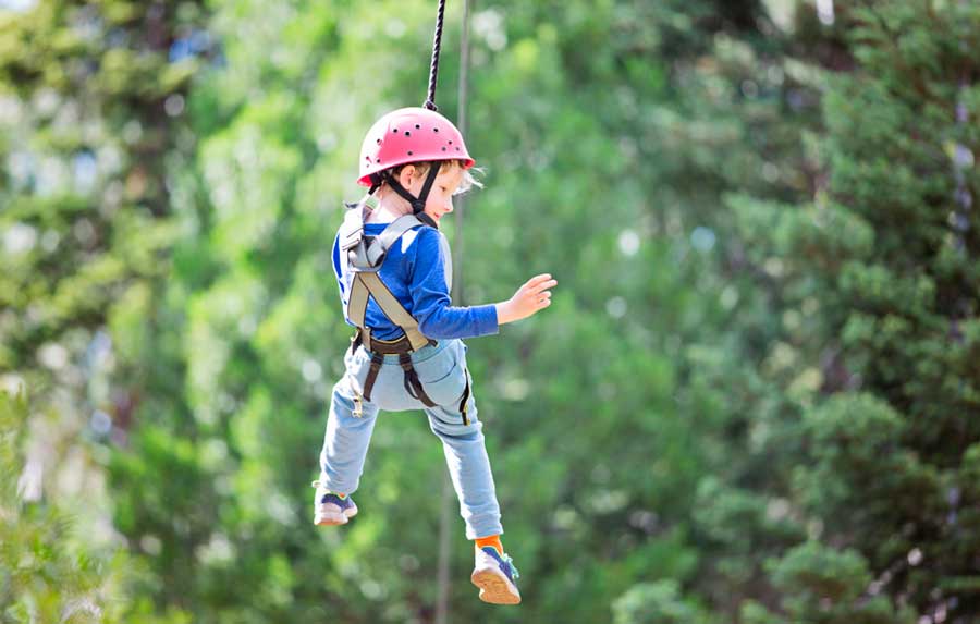 A boy enjoying his zipline experience in Vail