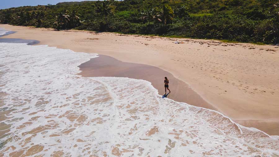 View of a woman on the shoreline of the Zoni Beach