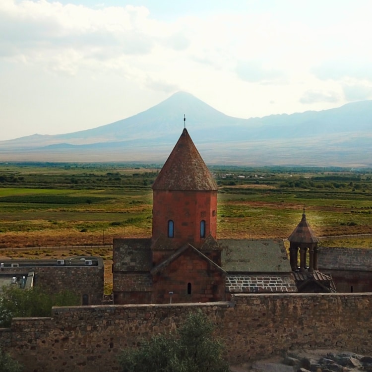 An old church at Khor Virap, framed by a majestic mountain backdrop