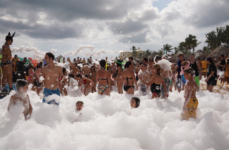 A beach party with bubbles at a club in Playa del Carmen
