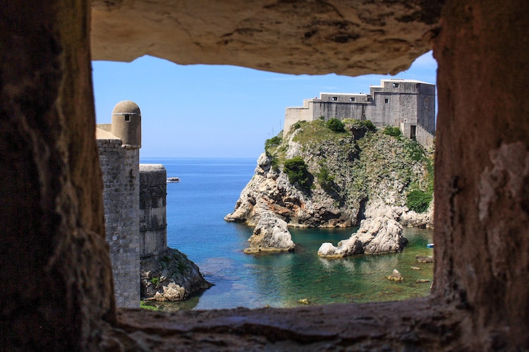 A view of the Dubrovnik fortress and the Adriatic sea through a gap in the old town walls