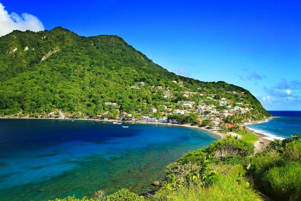 View of the houses at the hill side surrounded by the ocean