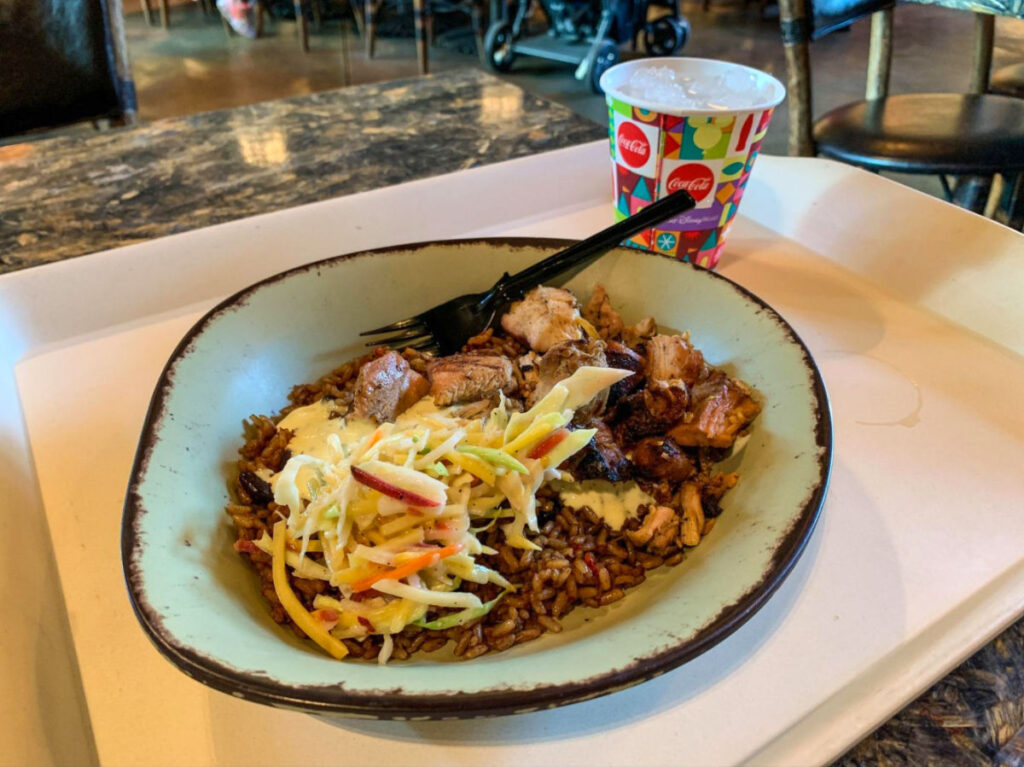 A wood-grilled chicken bowl with a refreshing drink, served on a tray at Satu’li Canteen