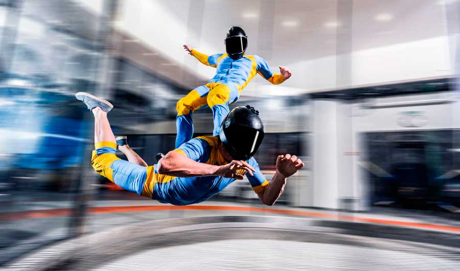 Two people enjoying indoor skydiving in iFly Denver